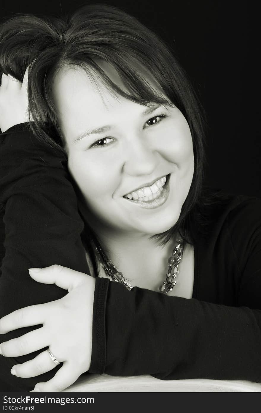 Headshot of beautiful brunette female on a black background