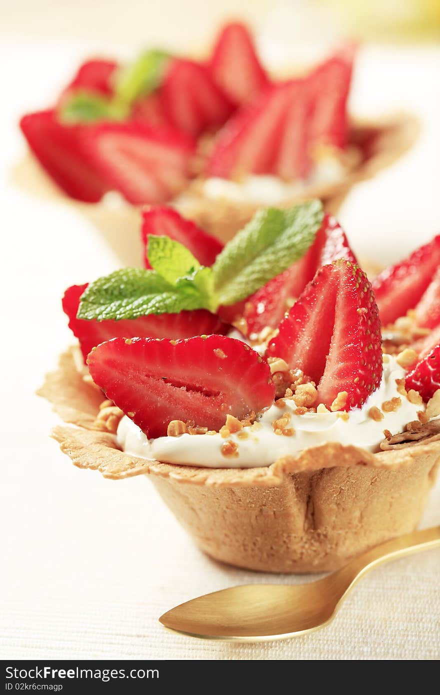 Small tarts with cream and fresh strawberries. Small tarts with cream and fresh strawberries