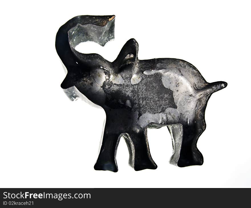 A vintage elephant shaped sugar dough cookie cutter on an isolated white background. A vintage elephant shaped sugar dough cookie cutter on an isolated white background.