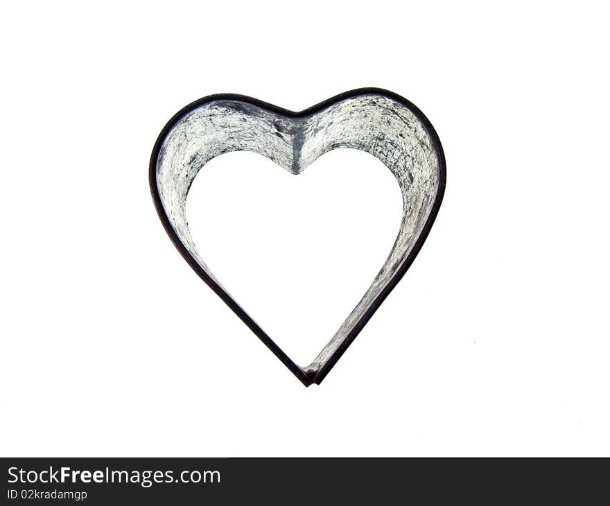 A vintage heart shaped sugar dough cookie cutter on an isolated white background. A vintage heart shaped sugar dough cookie cutter on an isolated white background.