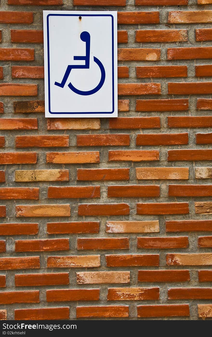 Brick Wall with Blue and White Sign