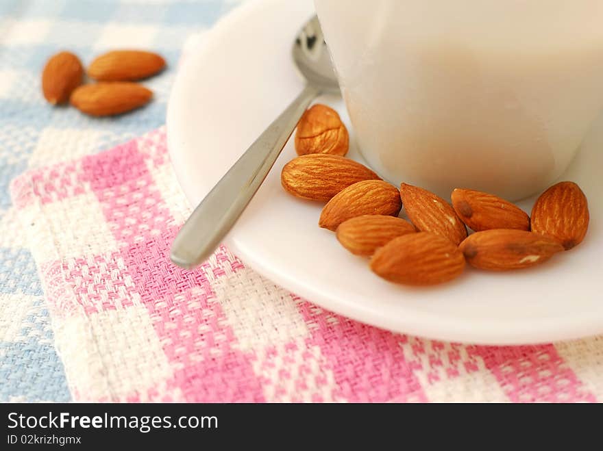 Closeup of almonds beside beverage