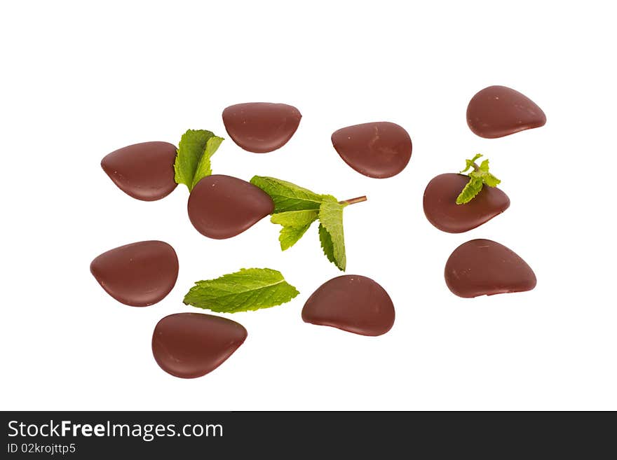 Chocolate petals with mint leaves isolated on white