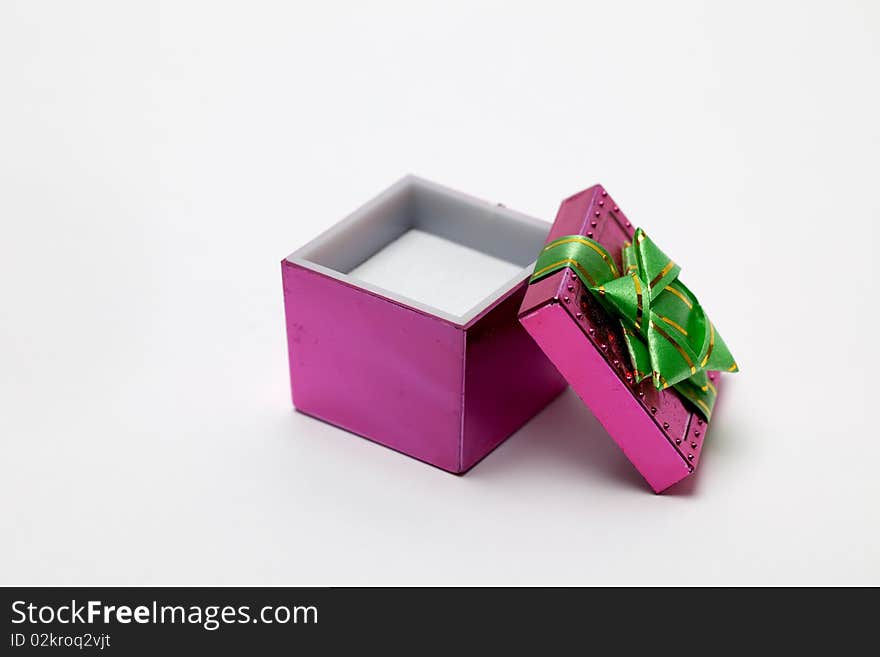 A small pink box open for a small gift. A small pink box open for a small gift.