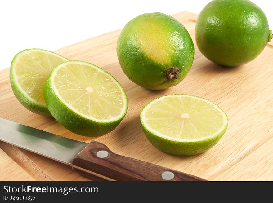 The limes and knife on the board