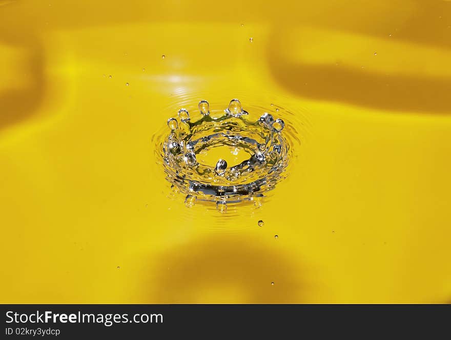 Splash of water on a yellow background. Splash of water on a yellow background