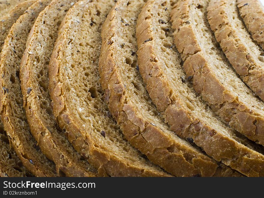 Sliced brown loaf bread background. Sliced brown loaf bread background