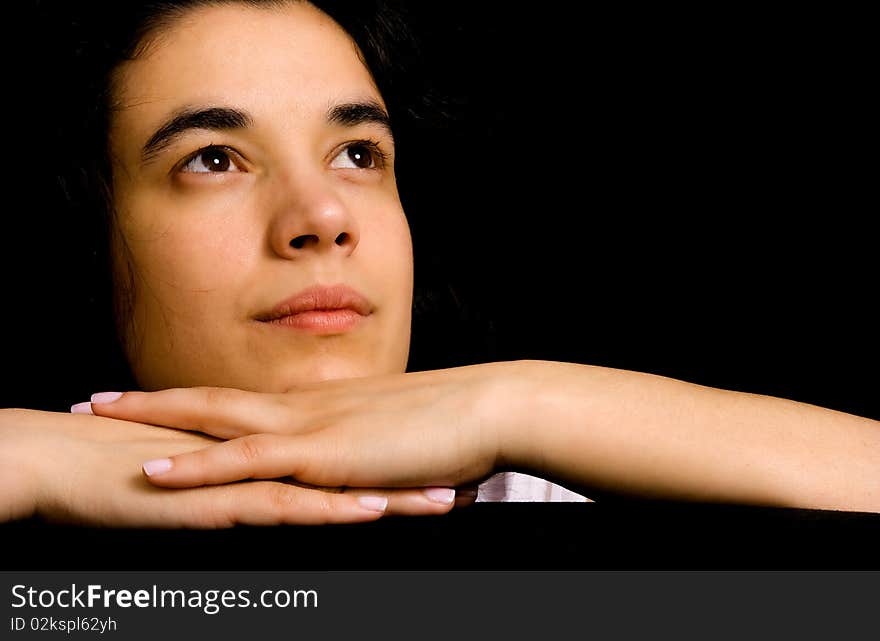 Young beautiful brunette woman portrait against black background