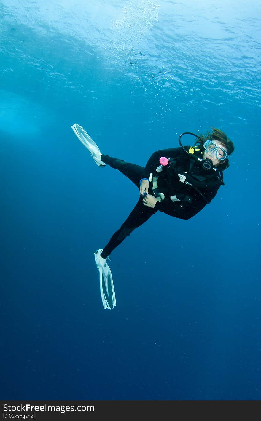 Woman scuba diver having fun on a dive. Woman scuba diver having fun on a dive