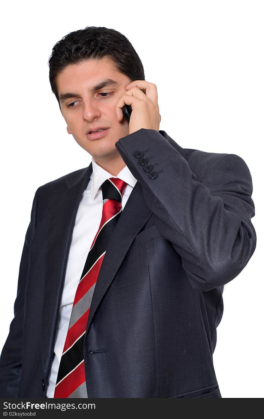 A young businesman speaking on the phone on a white background. A young businesman speaking on the phone on a white background.