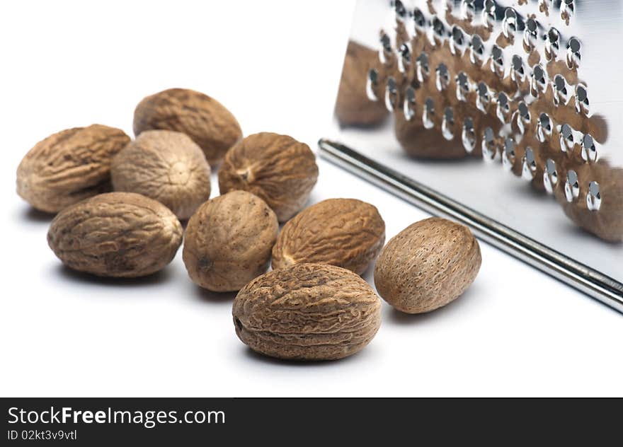 Nutmegs With A Grater On A White Background