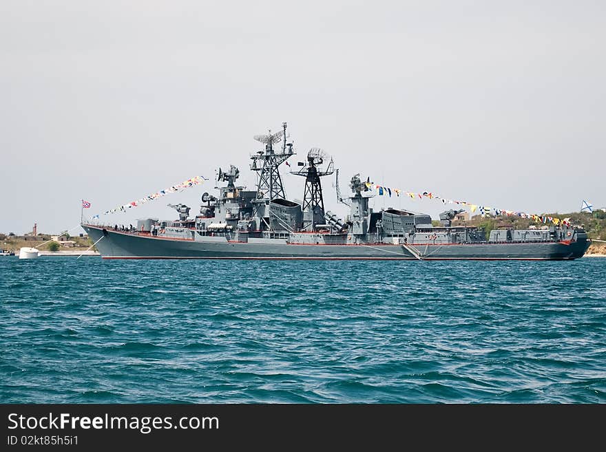 A grey navy warship anchored at sea. A grey navy warship anchored at sea