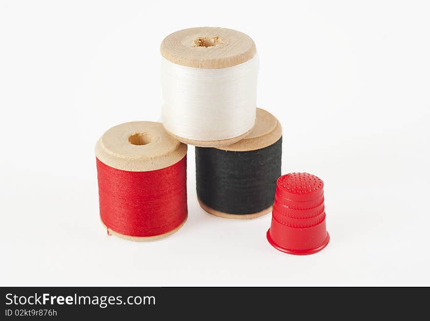 Cotton Reels And Thimble Isolated On White