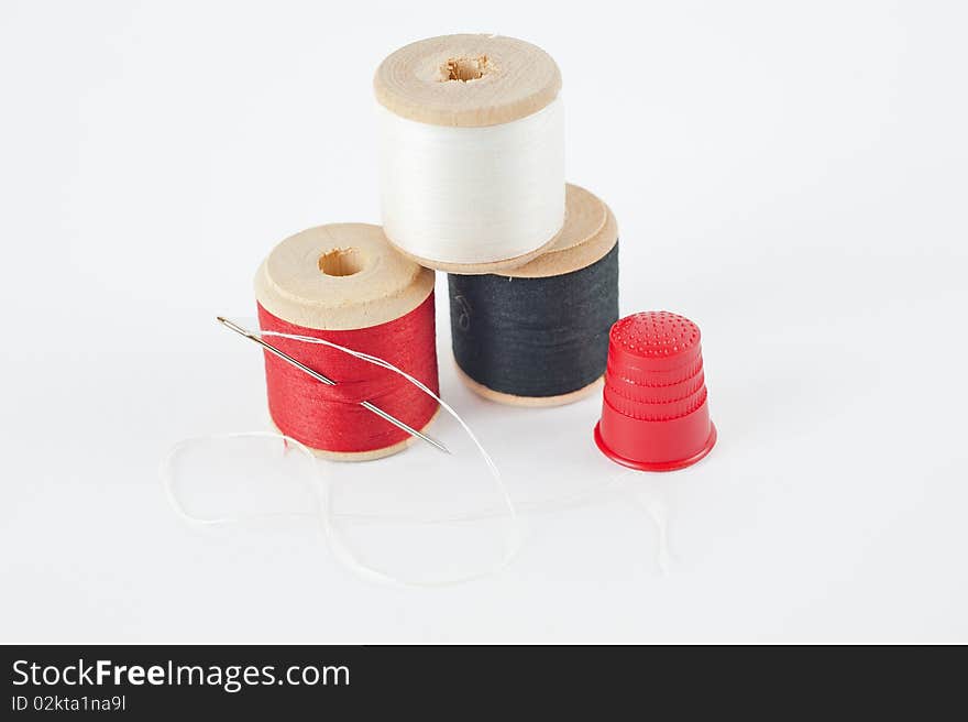 Cotton reels with needle and thimble