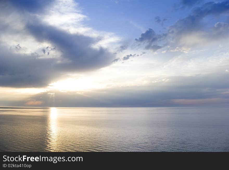 Sunbeams emanating from behind a clouds at sunset