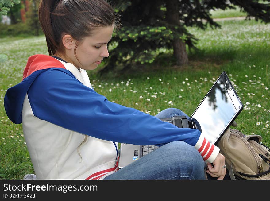 Young beautiful student learning outdoors with laptop. Young beautiful student learning outdoors with laptop