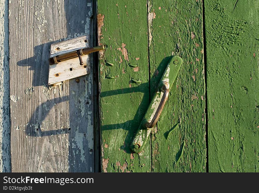 Boards of the old barn door, closed on the latch. Boards of the old barn door, closed on the latch