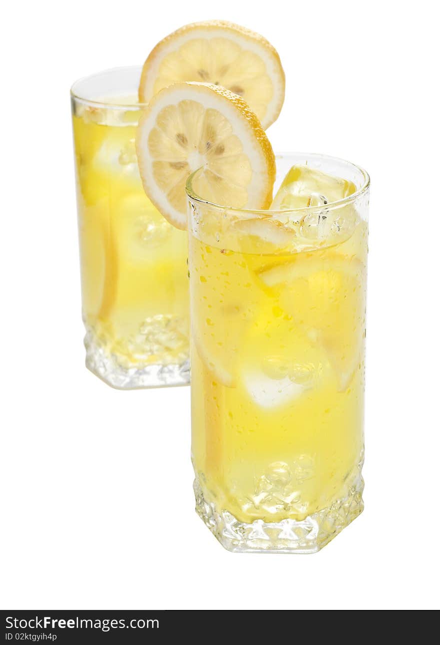 Two glasses of cold beverage with slices of lemon. Two glasses of cold beverage with slices of lemon