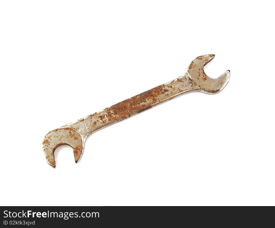 Rusty spanner  on a plane white background.