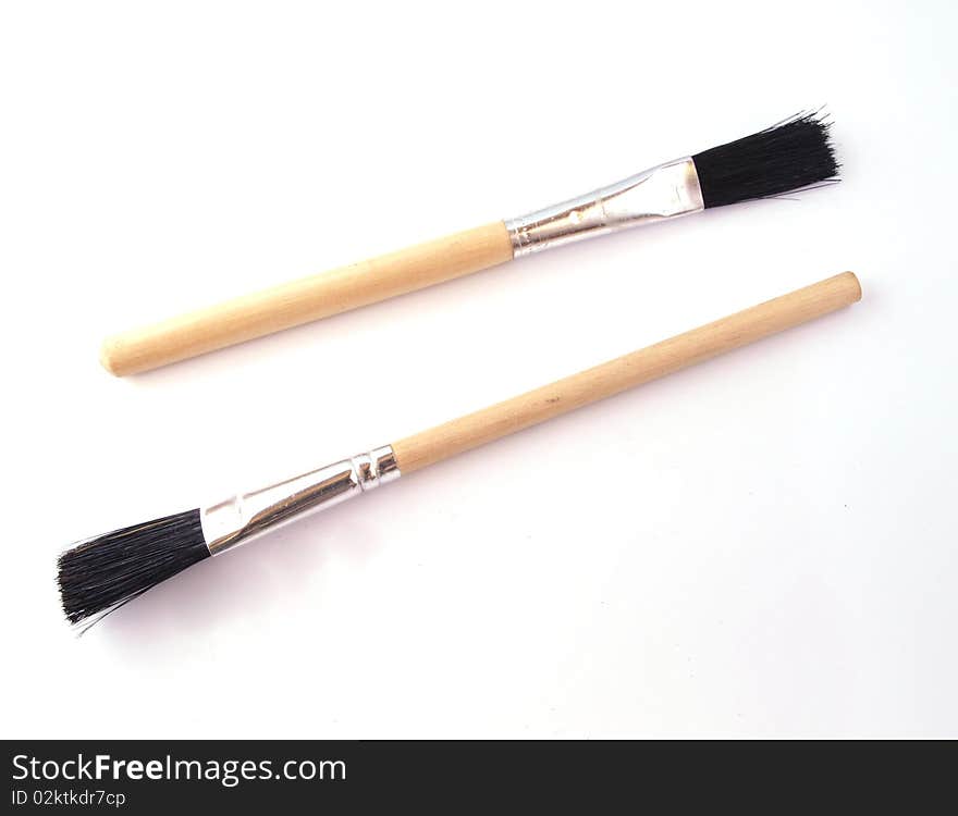 Two new paint brushes on a white background.