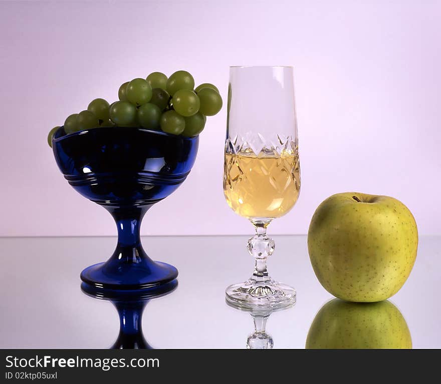 A glass of wine with fruits isolated on mirror. A glass of wine with fruits isolated on mirror