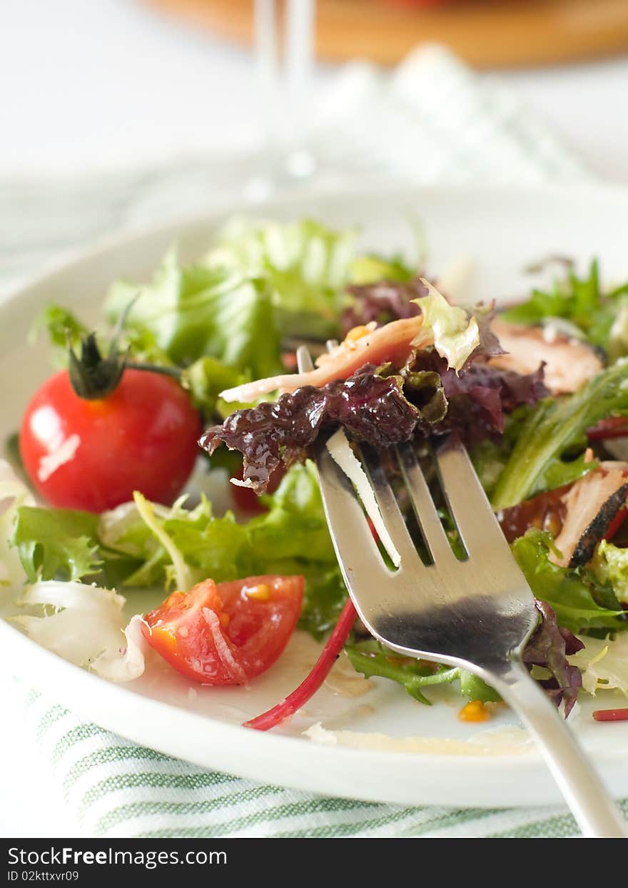 Very simple, yet elegant salad of mixed lettuce, cherry tomato,bacon and cheese