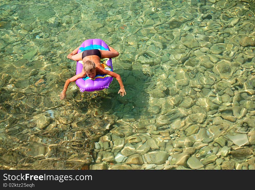 A kid is relaxing in Adriatic water of Croatia. A kid is relaxing in Adriatic water of Croatia