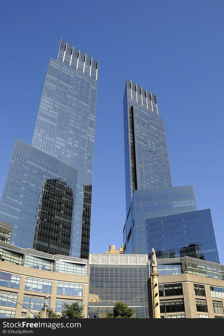 Towering skyscrapers and statue of Christopher Columbus at Columbus Circle in New York City.