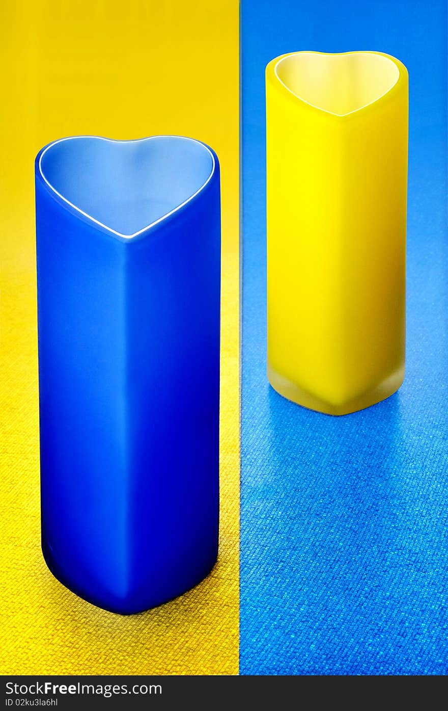 Colour glass bowls on yellow-blue background. Colour glass bowls on yellow-blue background