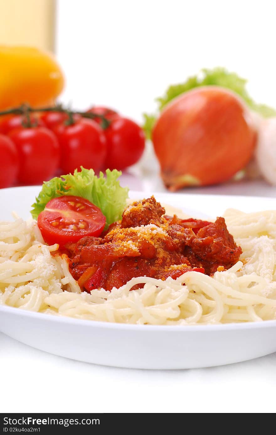 Closeup of spaghetti on white background with vegetables