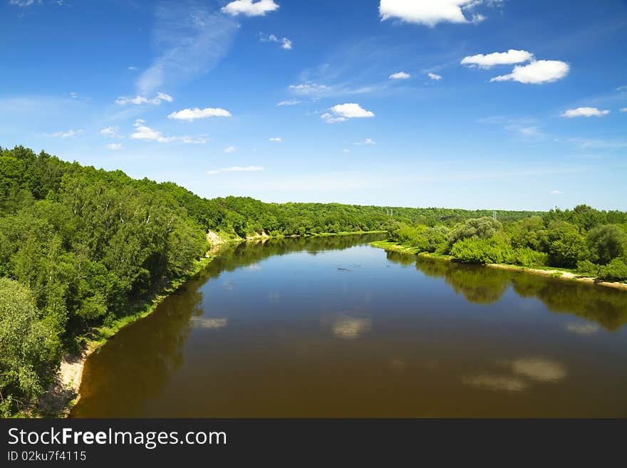 Summer river, blue cloudy sky