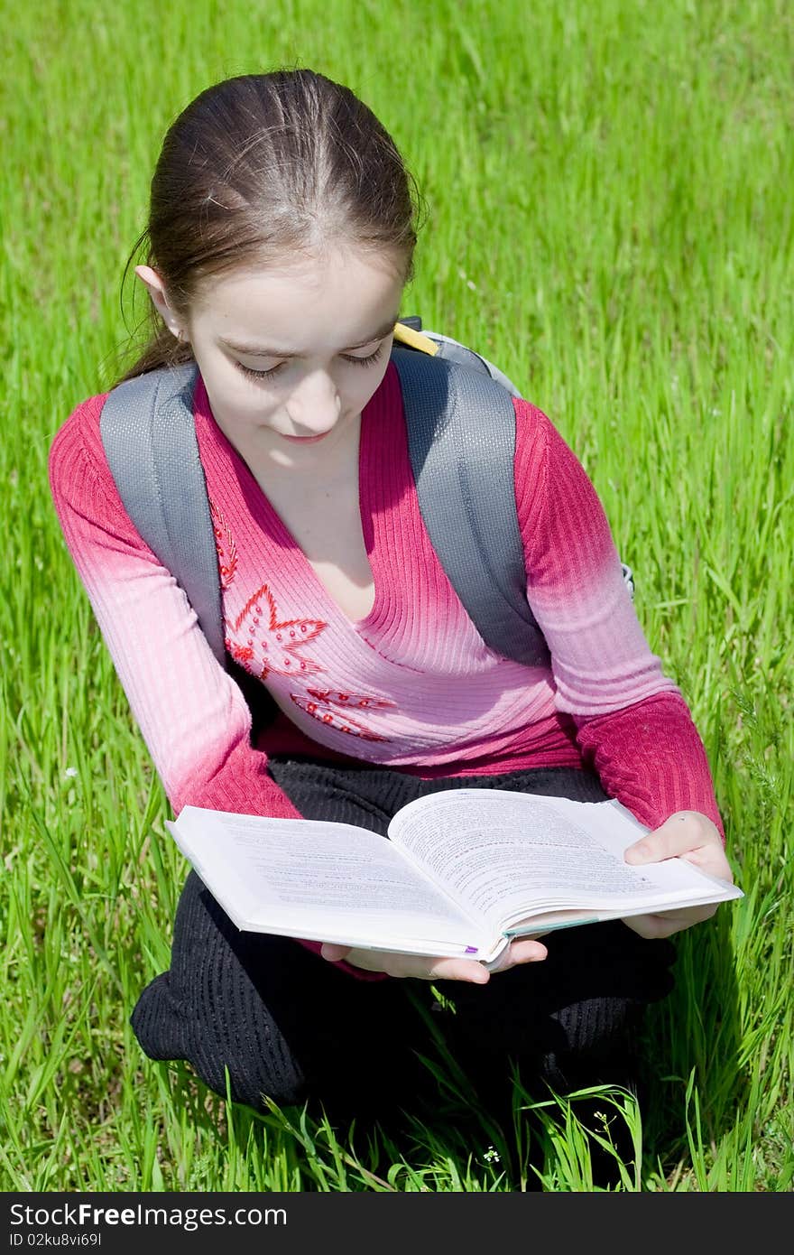 Girl with book. Studying on nature.