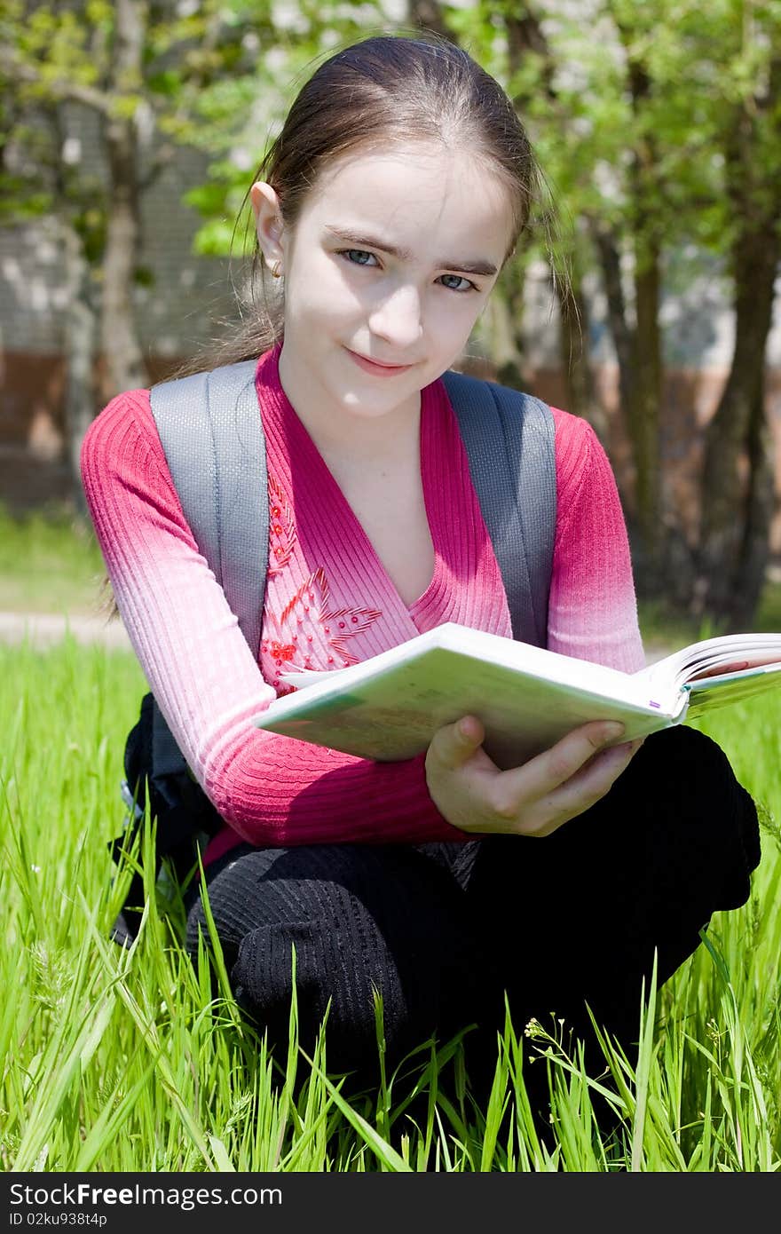 Girl with book. Studying on nature.