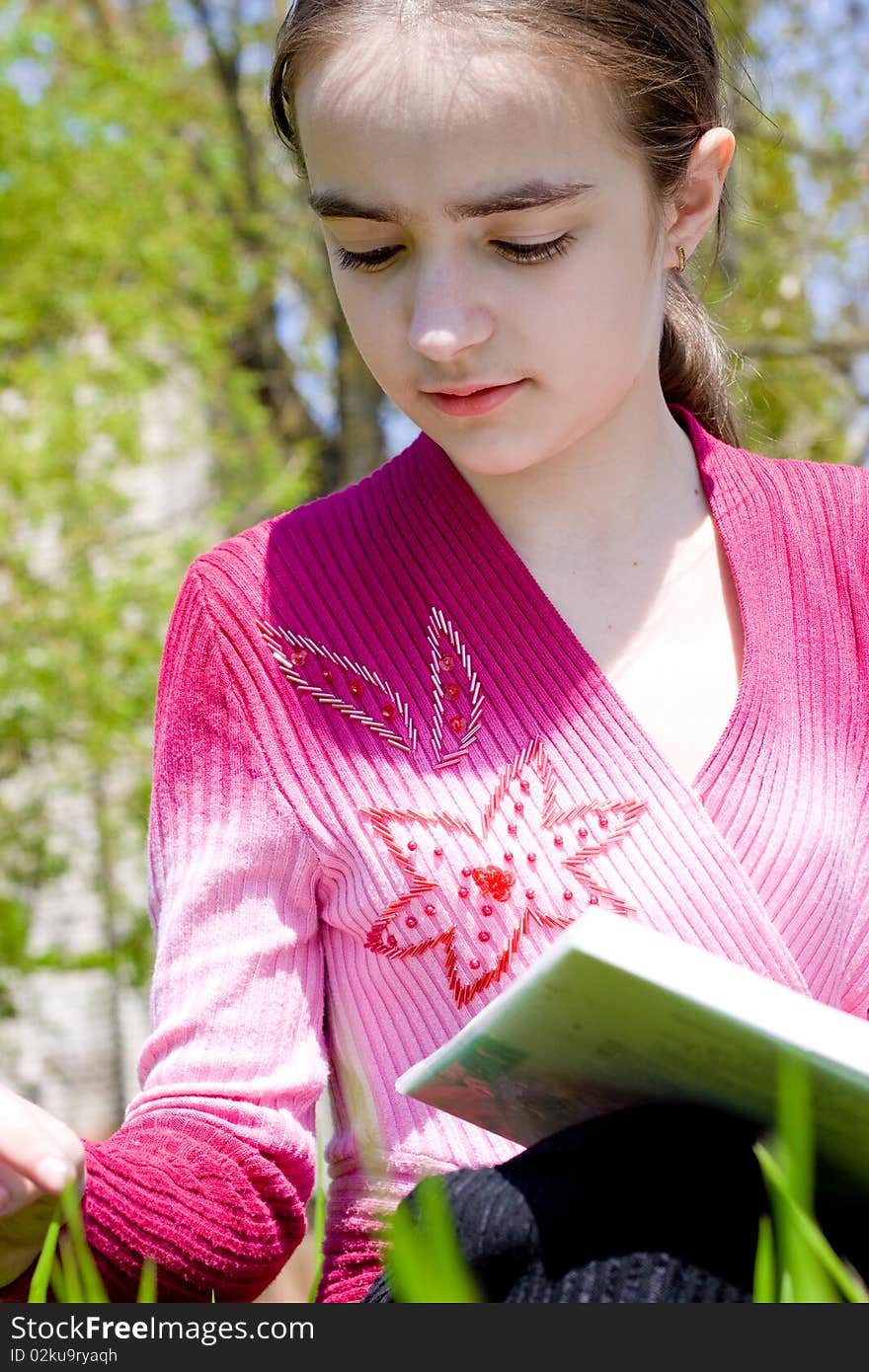 Girl with book. Studying on nature.