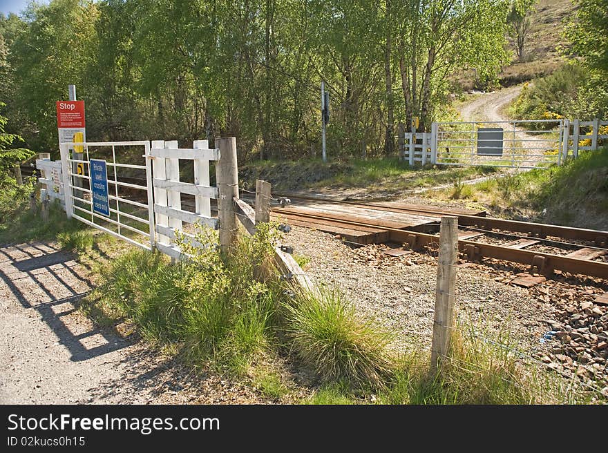 An image of a single line railway with gated level crossing and instructions on how to safely cross the line. An image of a single line railway with gated level crossing and instructions on how to safely cross the line.