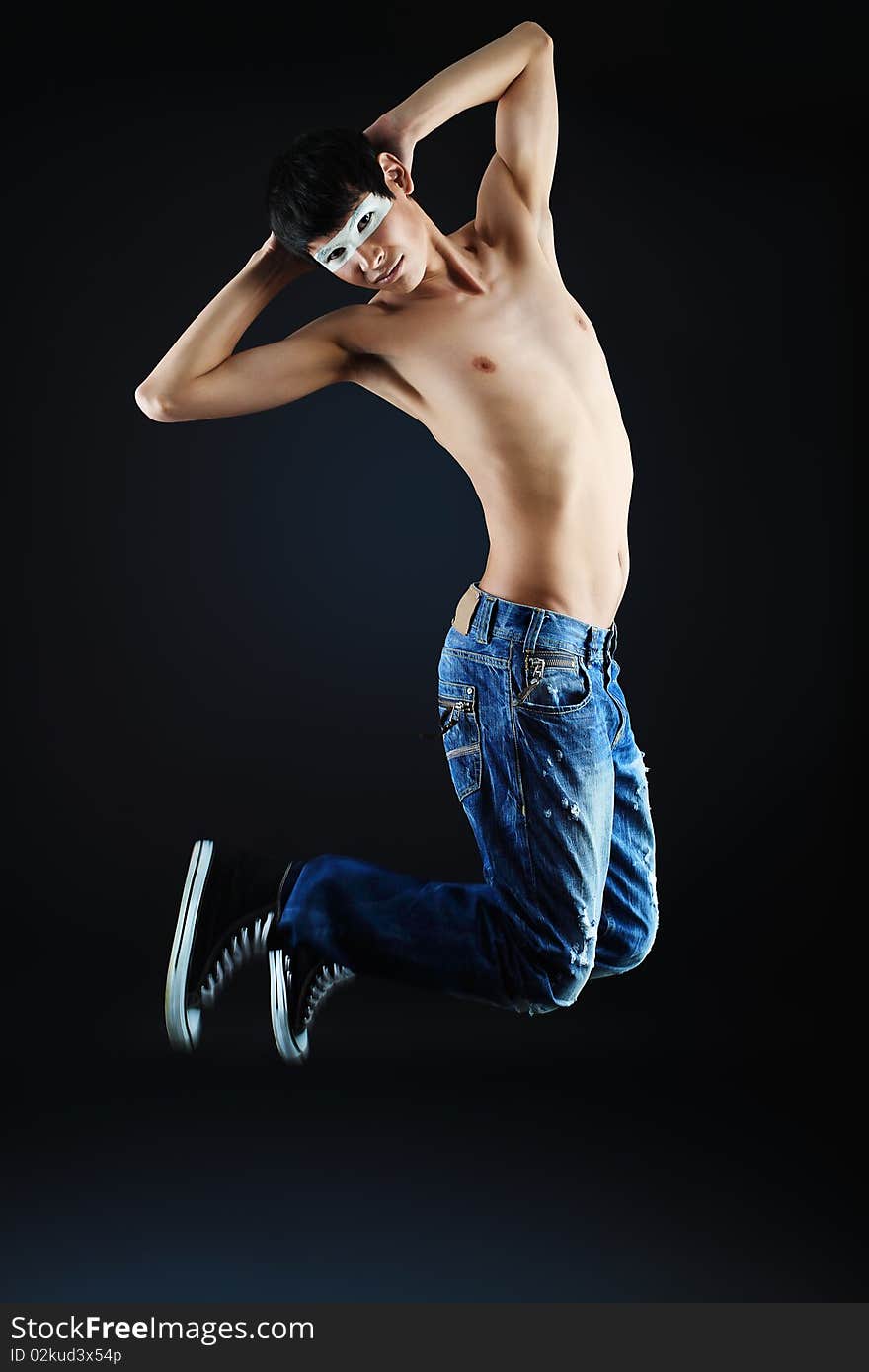 Shot of a jumping over black background young man. Shot of a jumping over black background young man.