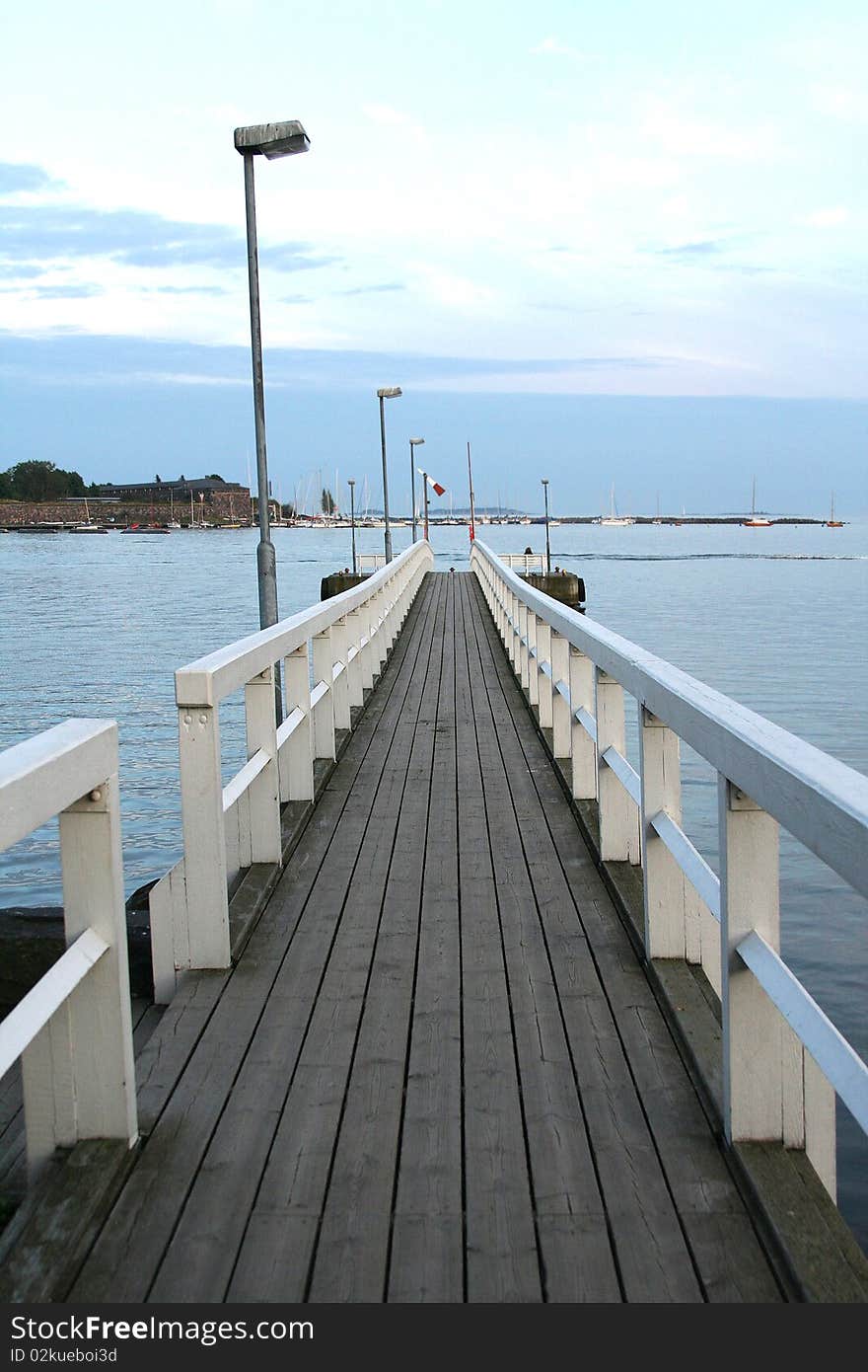 A wooden bridge over a big lake