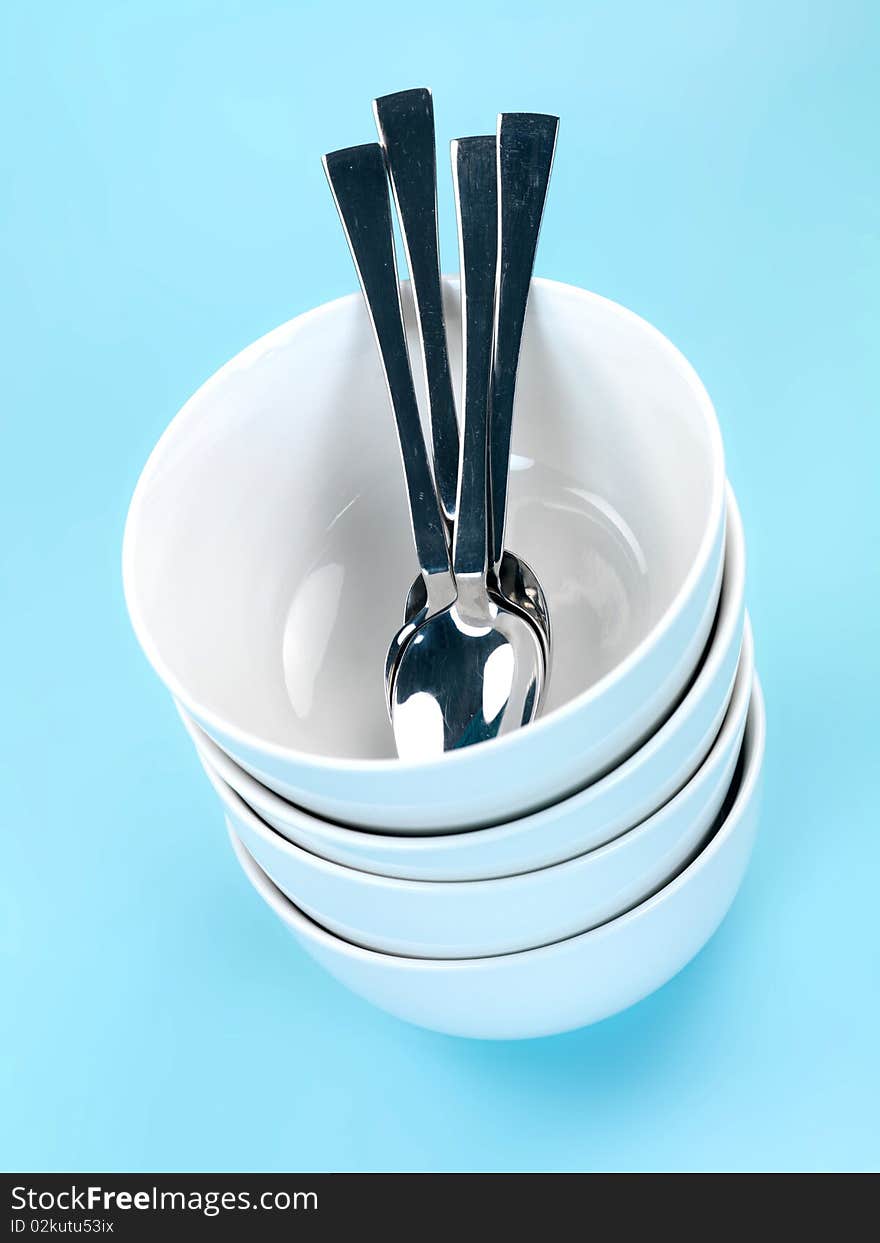 Plates and cutlery isolated against a blue background