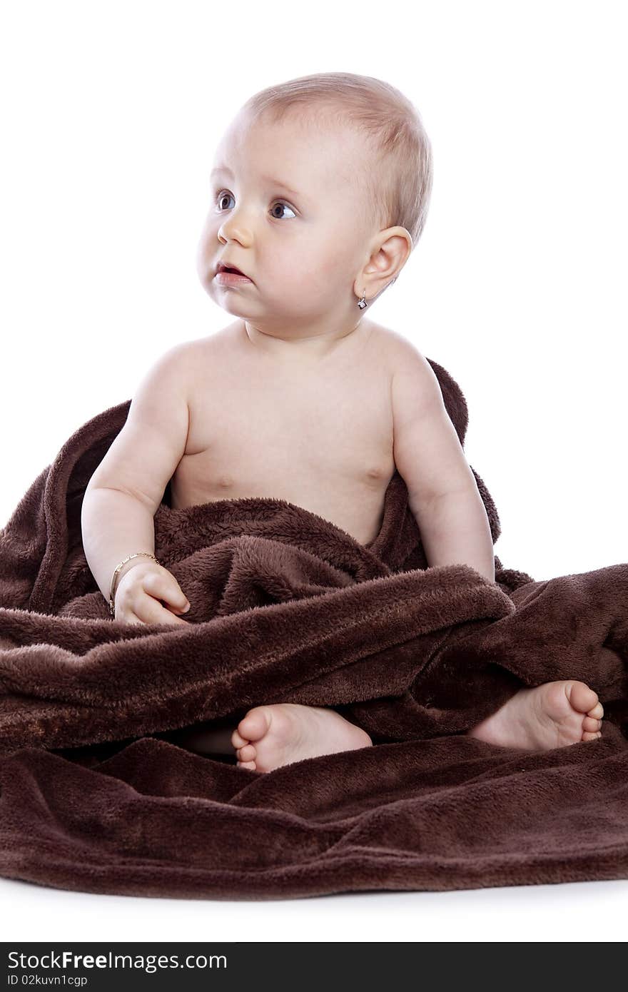 Beautiful baby under a brown towel