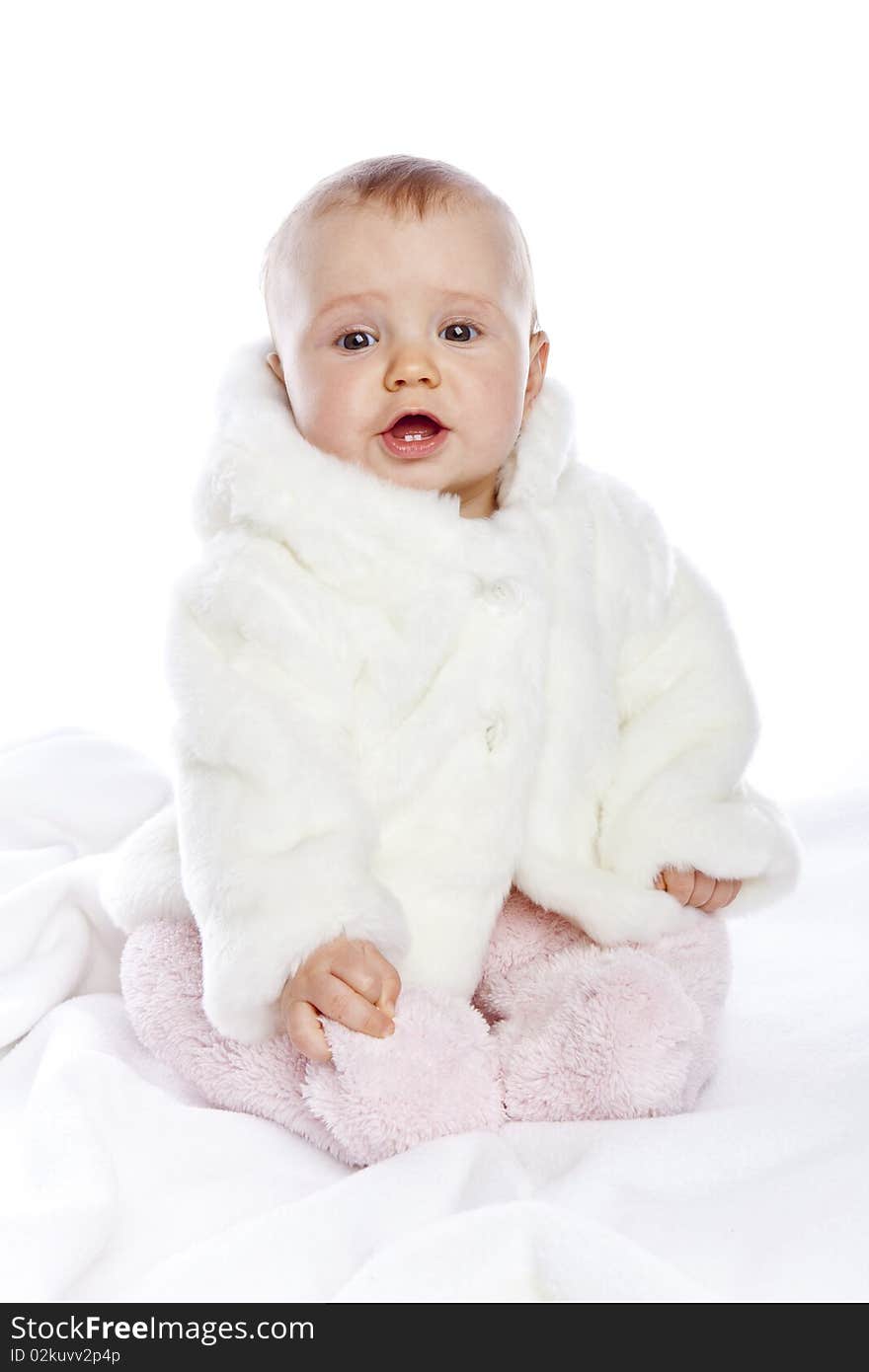 Cute little girl with a warm coat on white background