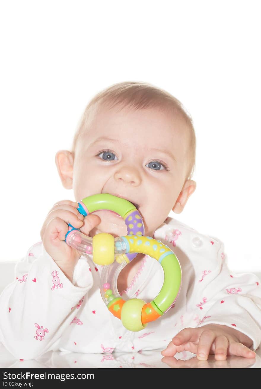 Portrait of the newborn child with a toy in a hand. Portrait of the newborn child with a toy in a hand