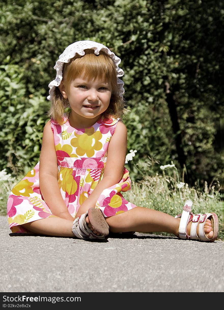 Cute little girl sit in pink dress