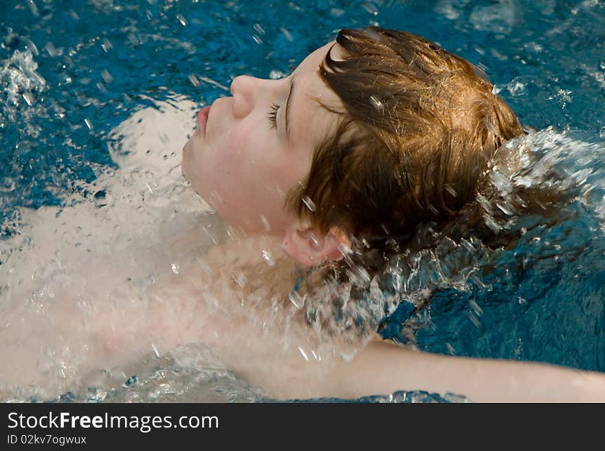 Boy with red hair in pool