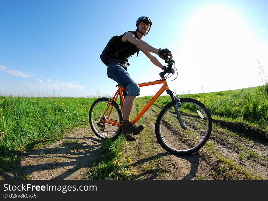 Dynamic composition with cyclist; warm lighting setup; attention - main focus is on the wheel and not on the face!. Dynamic composition with cyclist; warm lighting setup; attention - main focus is on the wheel and not on the face!