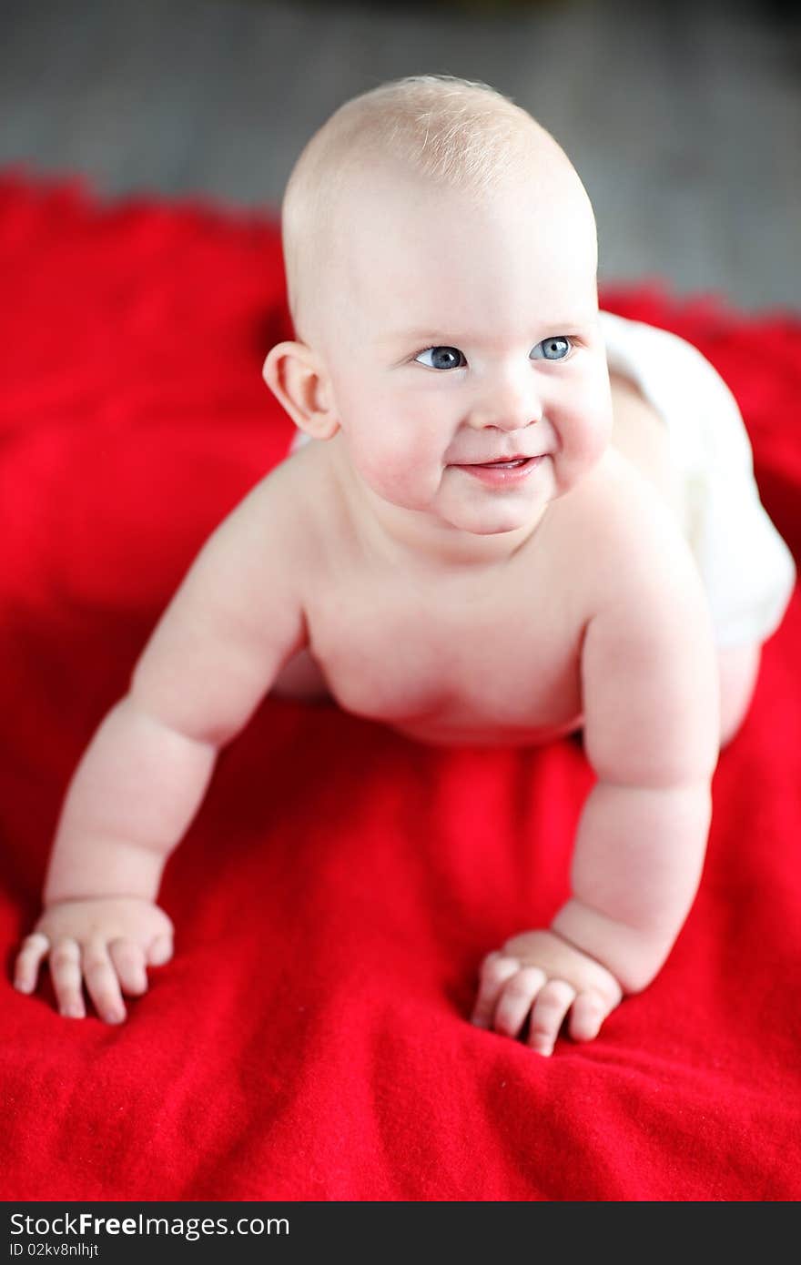 Little boy lying on red bed blanket. Little boy lying on red bed blanket.