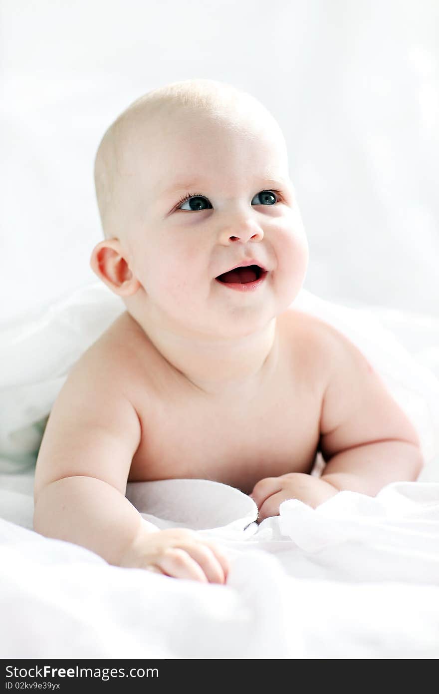 Little boy lying on white bed. Little boy lying on white bed