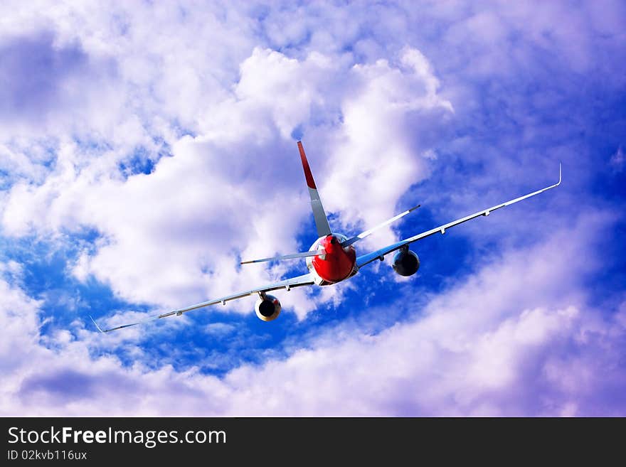 Airplane at fly on the sky with clouds