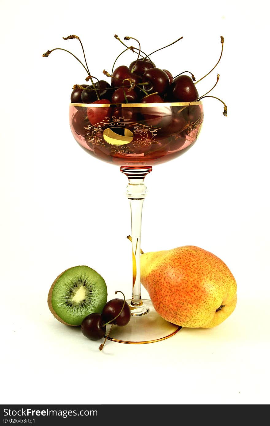 Still-life of kiwi, pear and cherry isolated