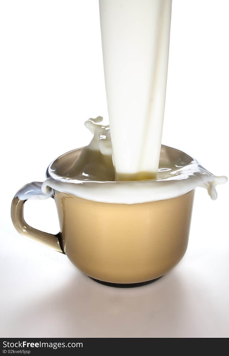 Milk is poured into a glass mug