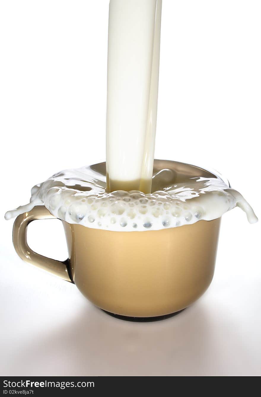 Milk is poured into a glass mug